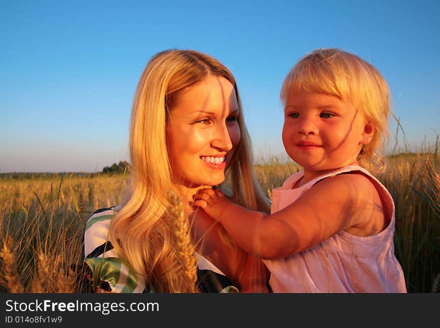 Mother And Child  Sit On Wheaten Field