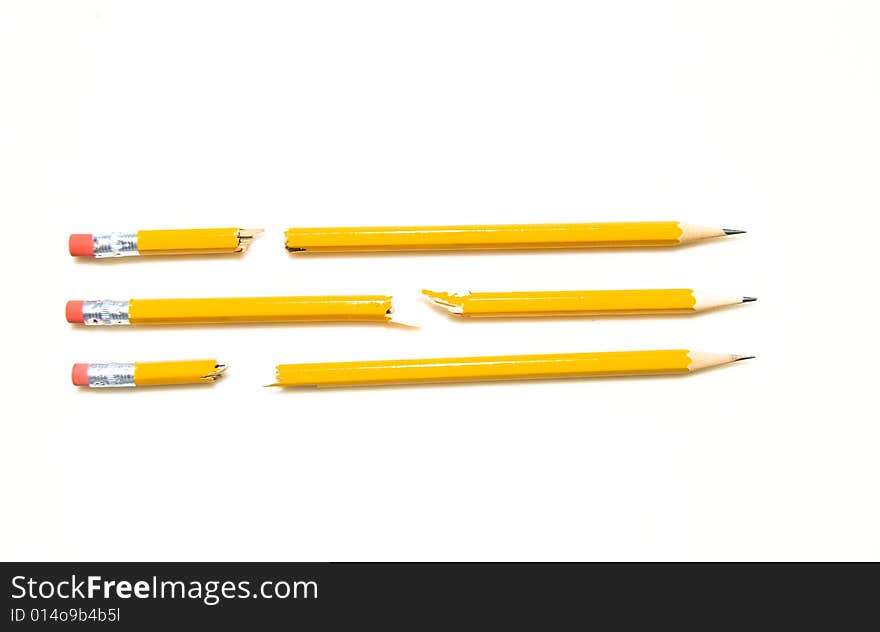 3 Broken Yellow No. 2 Pencils Lined Up In A Row Isolated on White