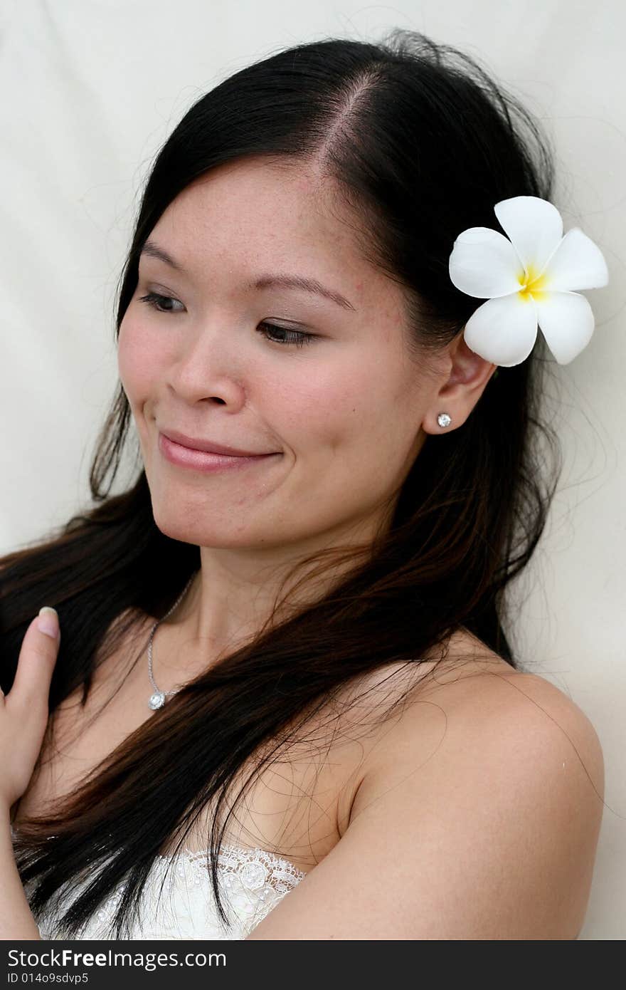 Beautiful Asian bride with a flower in her hair. Beautiful Asian bride with a flower in her hair.