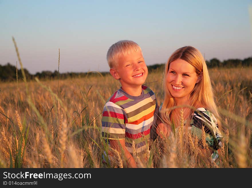 Mother and son   on wheaten field