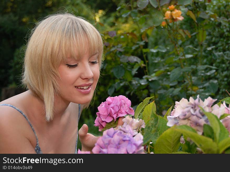 Young Blond Girl Smelling Flower