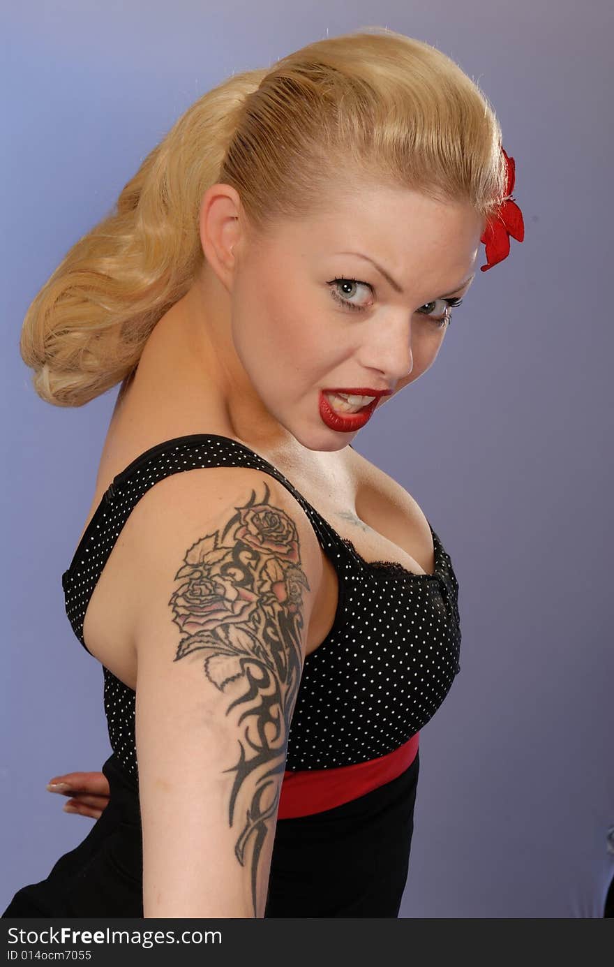 Portrait of cute blond pinup girl with tattoo. Portrait of cute blond pinup girl with tattoo