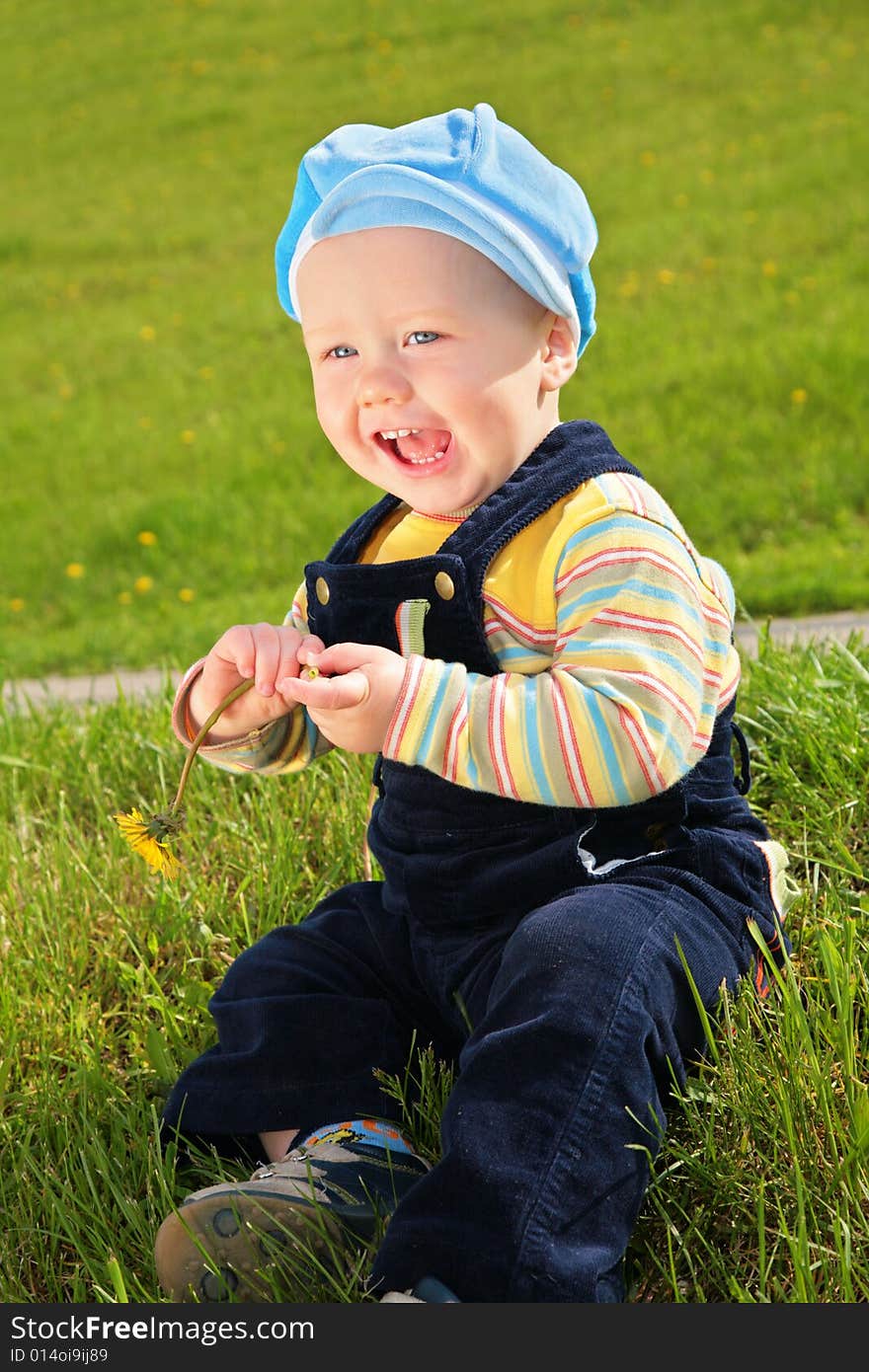 Child with dandelion on meadow