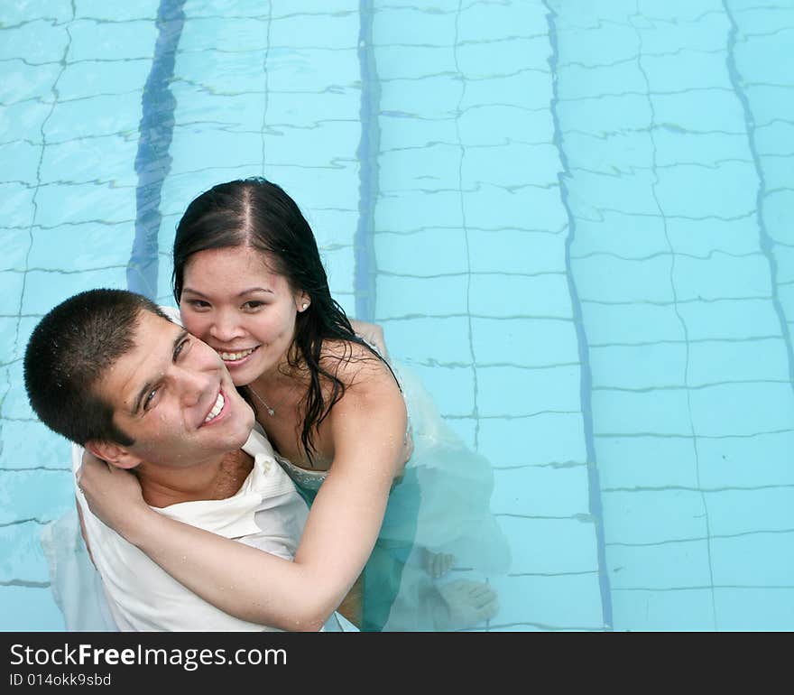 Happy couple in the swimming pool.