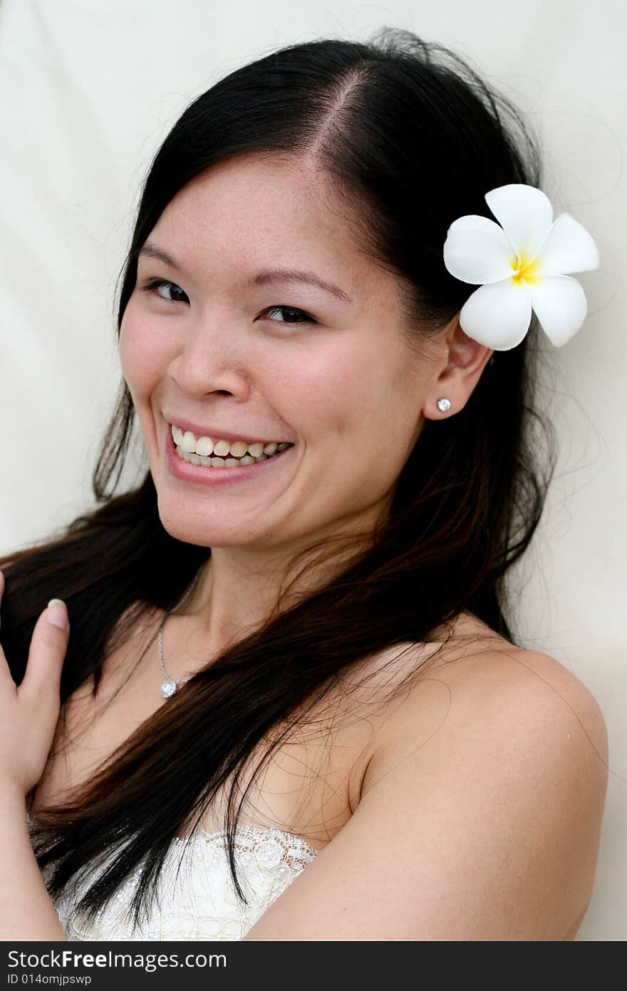 Beautiful Asian bride with a flower in her hair. Beautiful Asian bride with a flower in her hair.