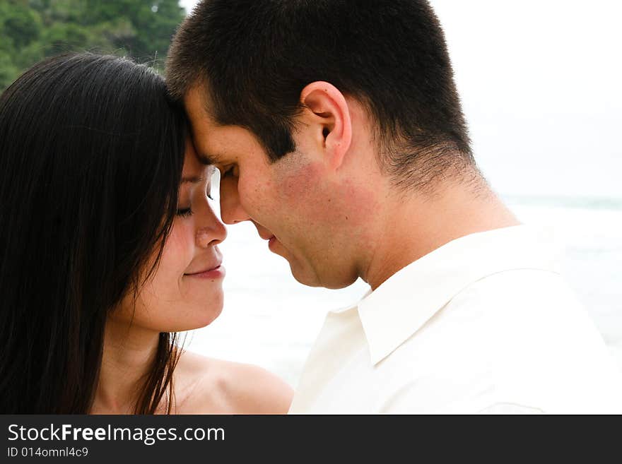 Attractive bride and groom on their wedding day share an intimate moment. Attractive bride and groom on their wedding day share an intimate moment.