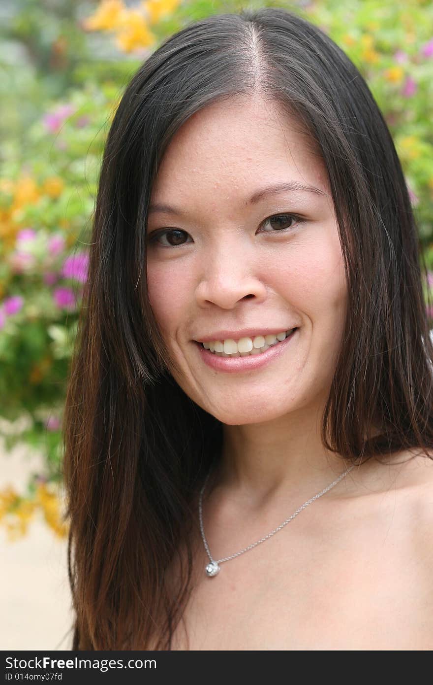 Beautiful Asian woman in a flower garden.