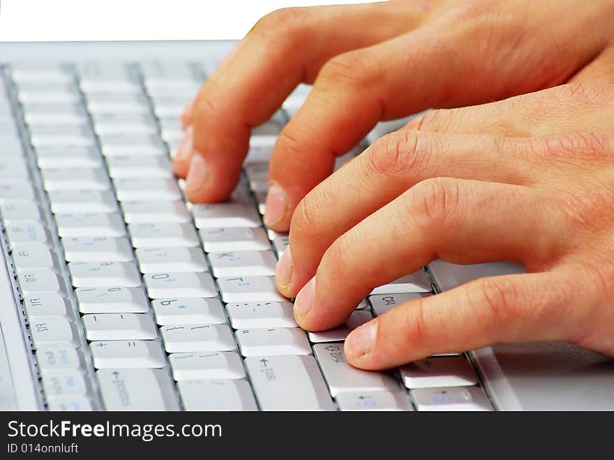 Male hands typing on a laptop