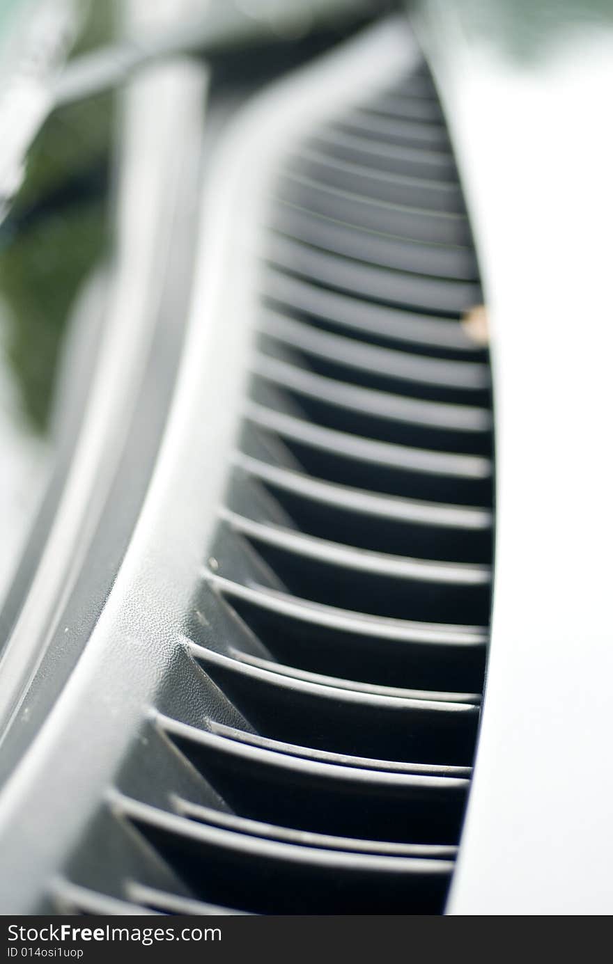 Gray automobile hood vent on a cloudy day. Gray automobile hood vent on a cloudy day.