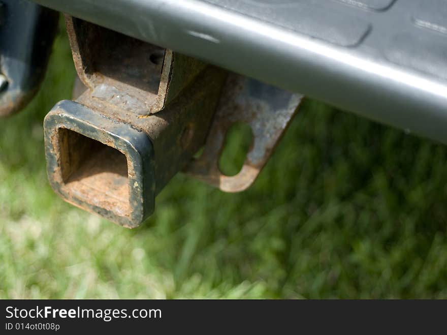 Rusty trailer hook attached to vehicle. Rusty trailer hook attached to vehicle