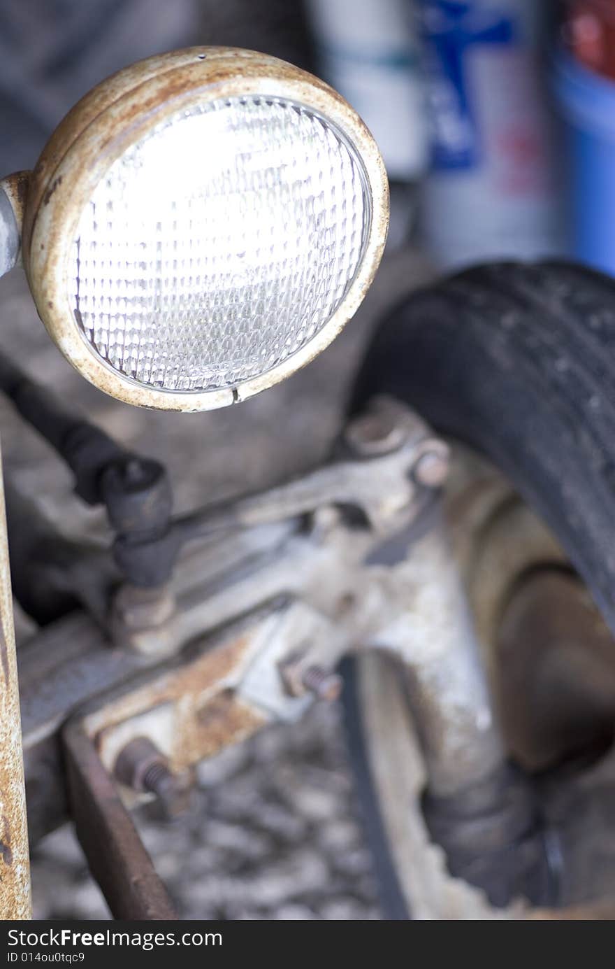 Old time headlamp with tire in background. Old time headlamp with tire in background