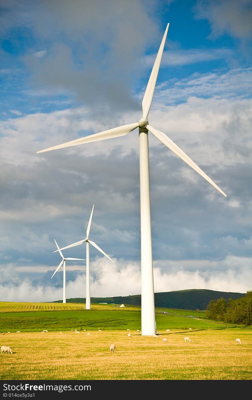 Beautiful green meadow with Wind turbines generating electricity. Beautiful green meadow with Wind turbines generating electricity