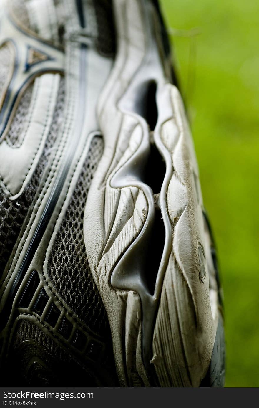 Photograph of the bottom of a dark colored sneaker. Photograph of the bottom of a dark colored sneaker