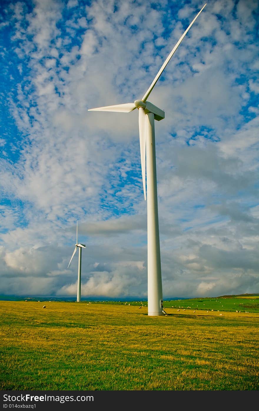 Beautiful green meadow with Wind turbines generating electricity. Beautiful green meadow with Wind turbines generating electricity