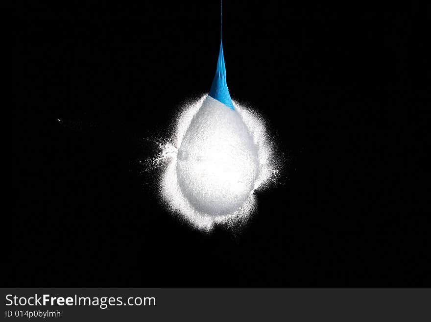 Balloon with water frozen in the moment when the bullet is flying out of it. Balloon with water frozen in the moment when the bullet is flying out of it