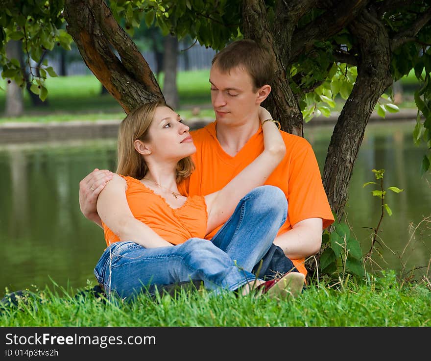 Loving couple has a rest under a tree