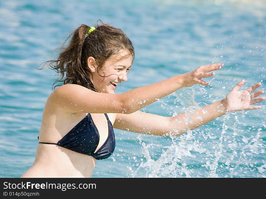 Younger girl reposing on sea by summer