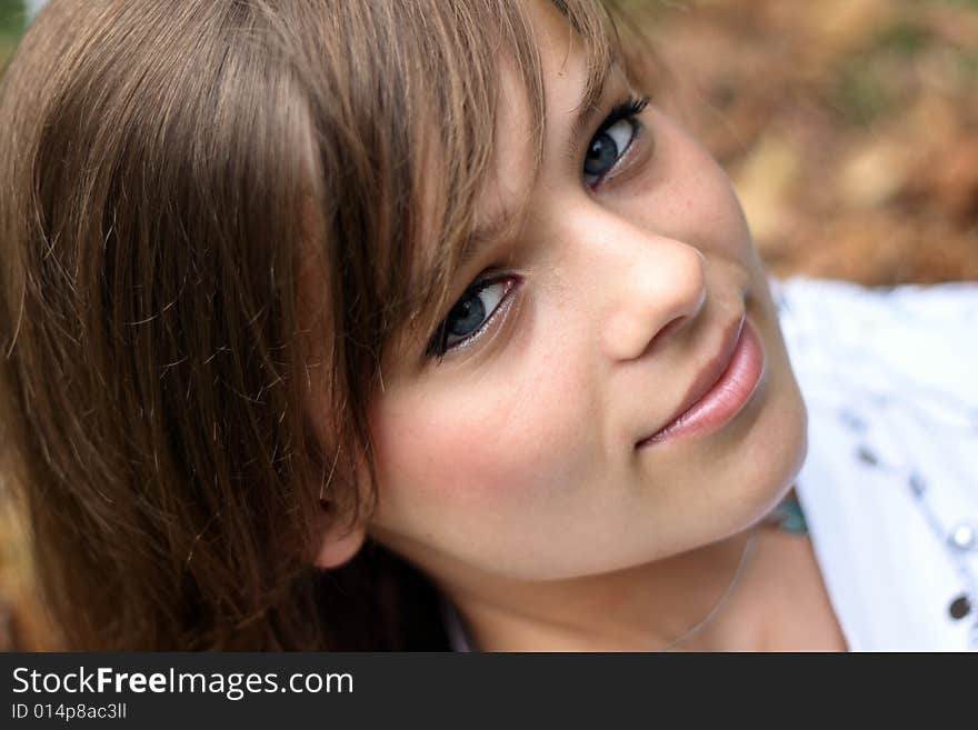 A picture of a girl, smiling and looking on the camera. A picture of a girl, smiling and looking on the camera