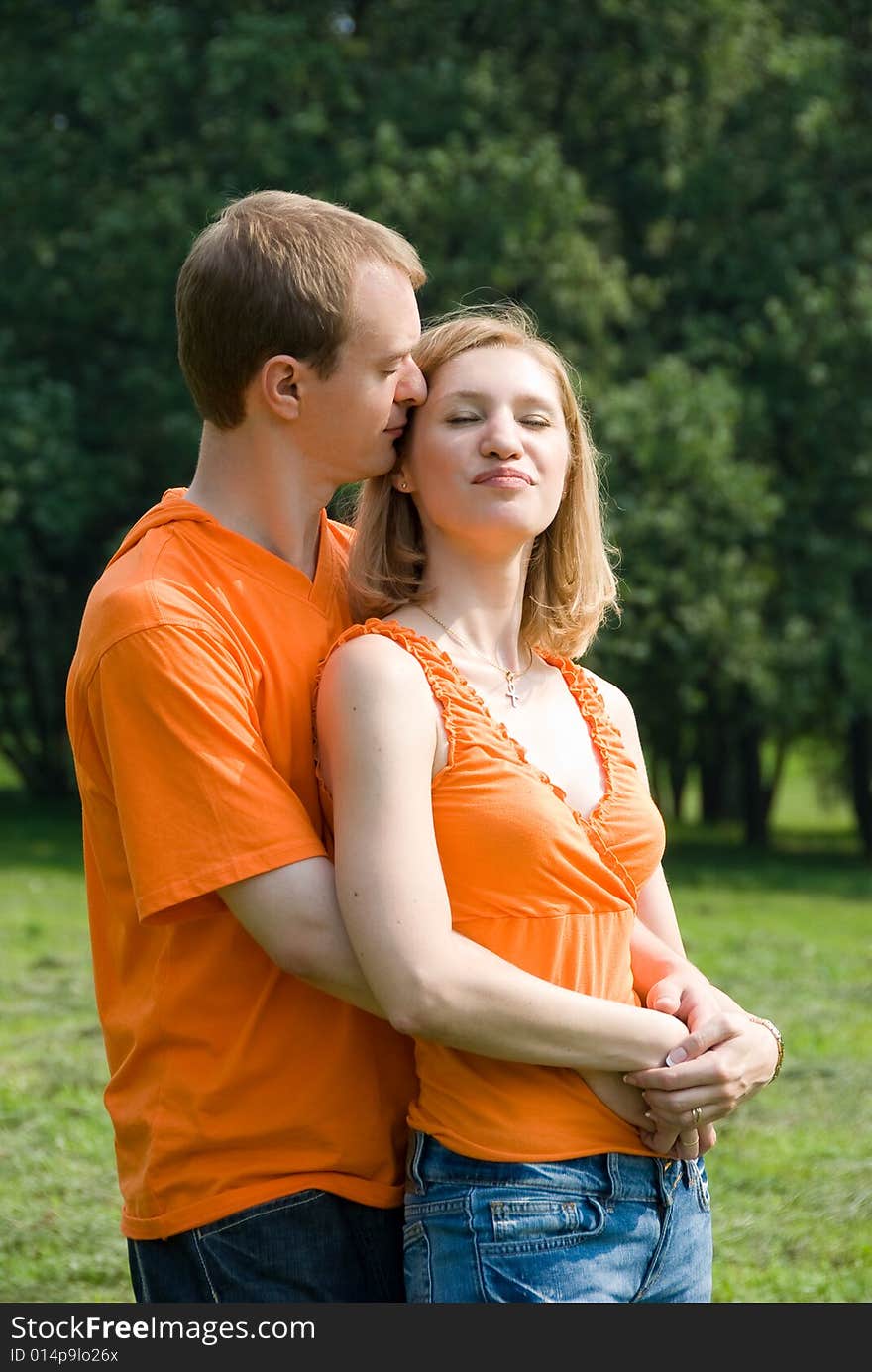 Loving couple embraces on a summer nature