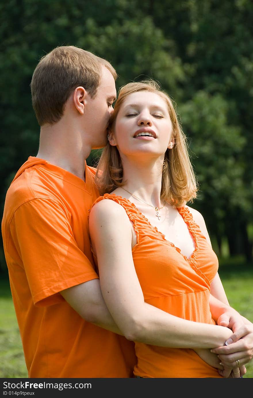 Loving couple embraces on a summer nature