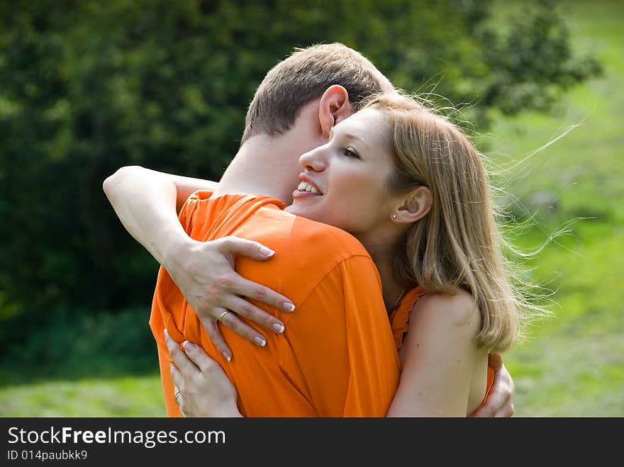 Loving couple embraces on a summer nature
