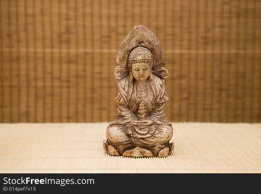 Close up of buddha on bamboo background