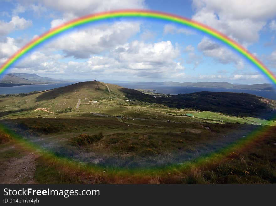 The view from a hillside on Bear island county Cork Ireland on a wet day with rainbow in background. The view from a hillside on Bear island county Cork Ireland on a wet day with rainbow in background