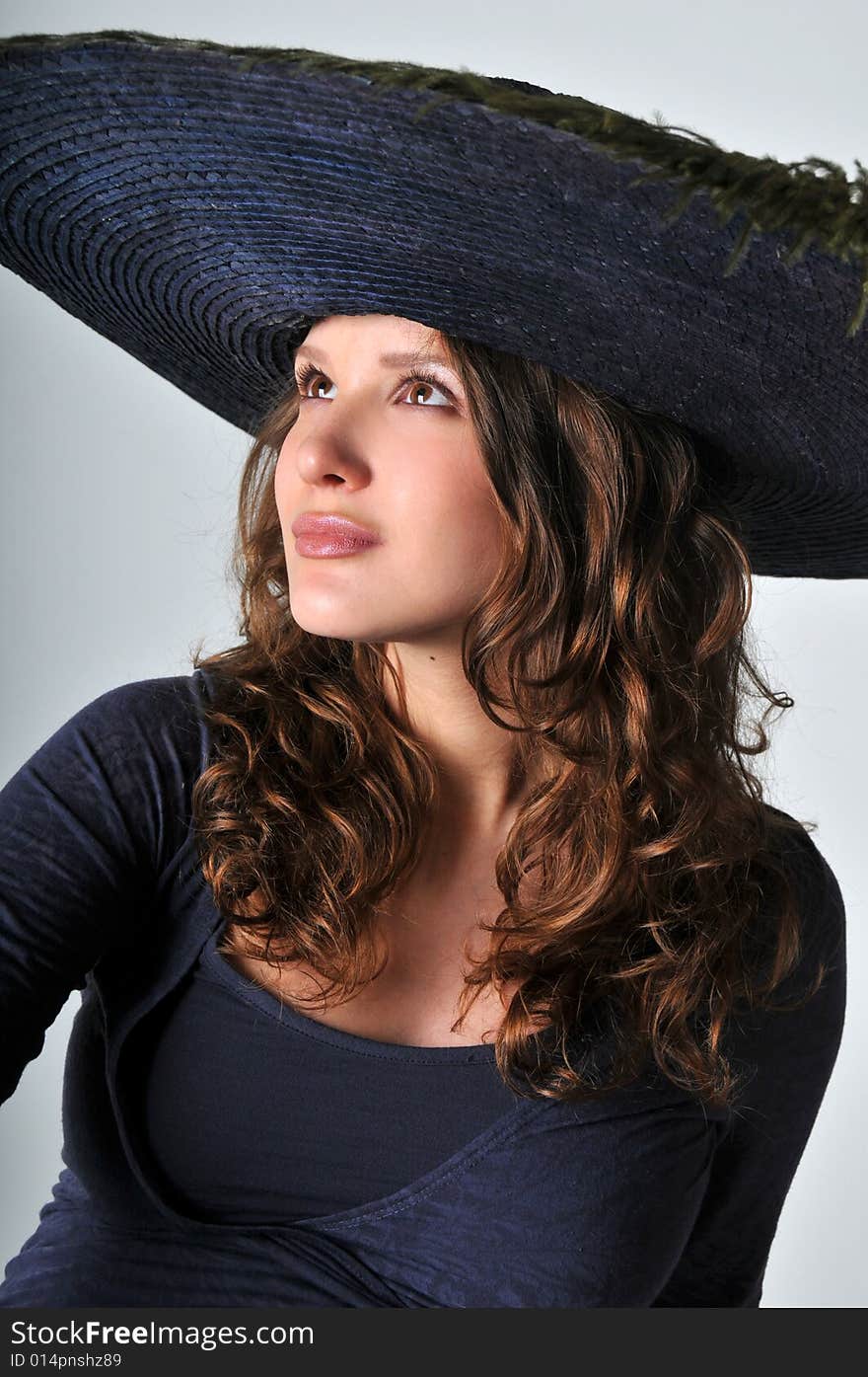 A portrait of beautiful pregnant women is in a hat. A portrait of beautiful pregnant women is in a hat