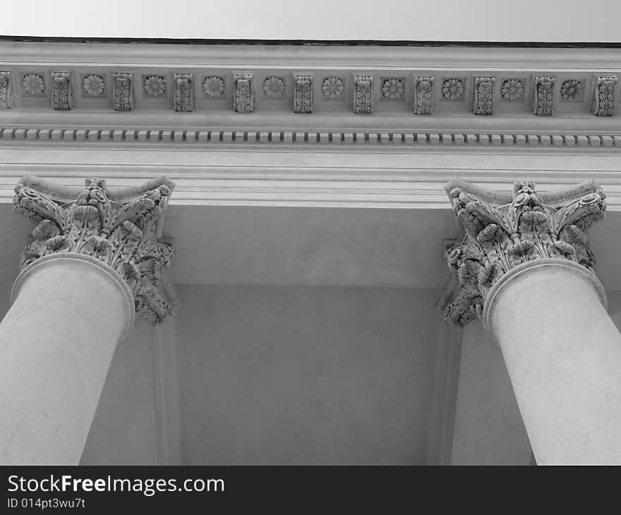 Columns supporting a colonnade in Valtice. Notice the Corinthian style of the head of the column and distinctive flower pattern on a ceiling they support. Columns supporting a colonnade in Valtice. Notice the Corinthian style of the head of the column and distinctive flower pattern on a ceiling they support.