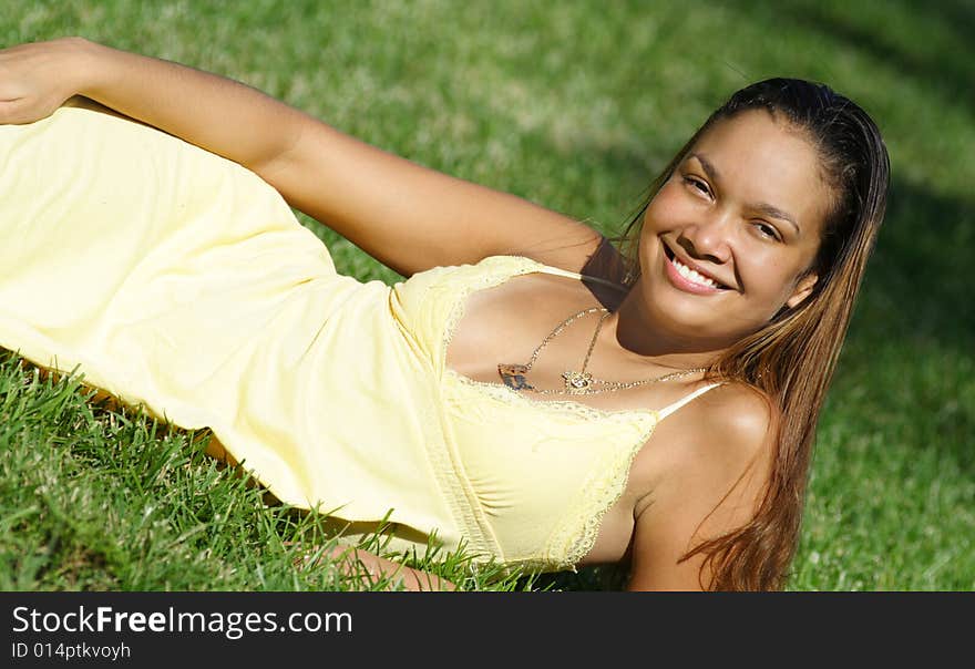 Young Woman Laying On Grass