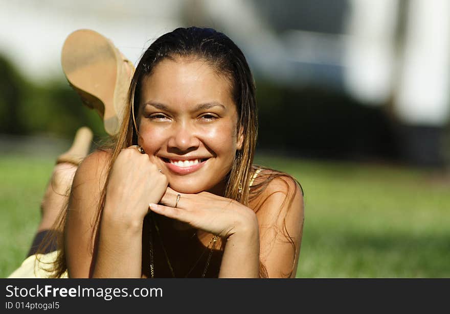 Young Woman Laying On Grass