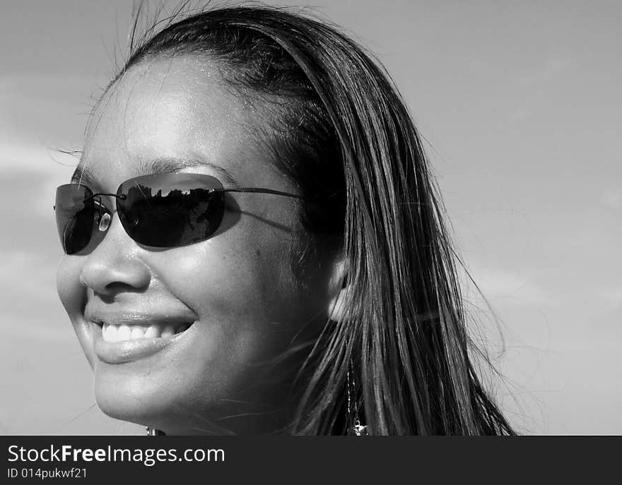 Black and white image of a young woman smiling. Black and white image of a young woman smiling