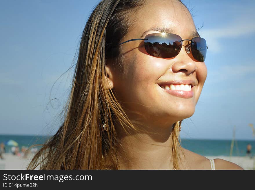 Image of a young woman smiling on a blue sky. Image of a young woman smiling on a blue sky