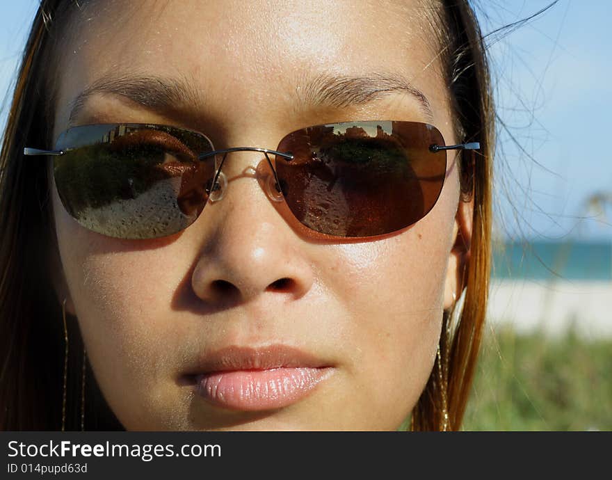 Beautiful young female wearing stylish sunglasses. Beautiful young female wearing stylish sunglasses