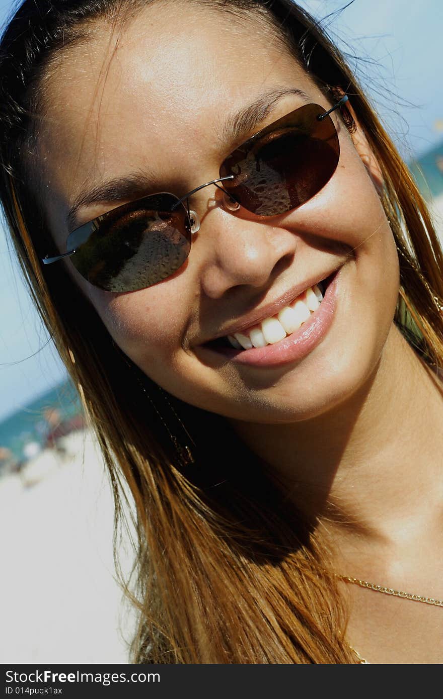 Image of a young woman smiling on a blue sky. Image of a young woman smiling on a blue sky