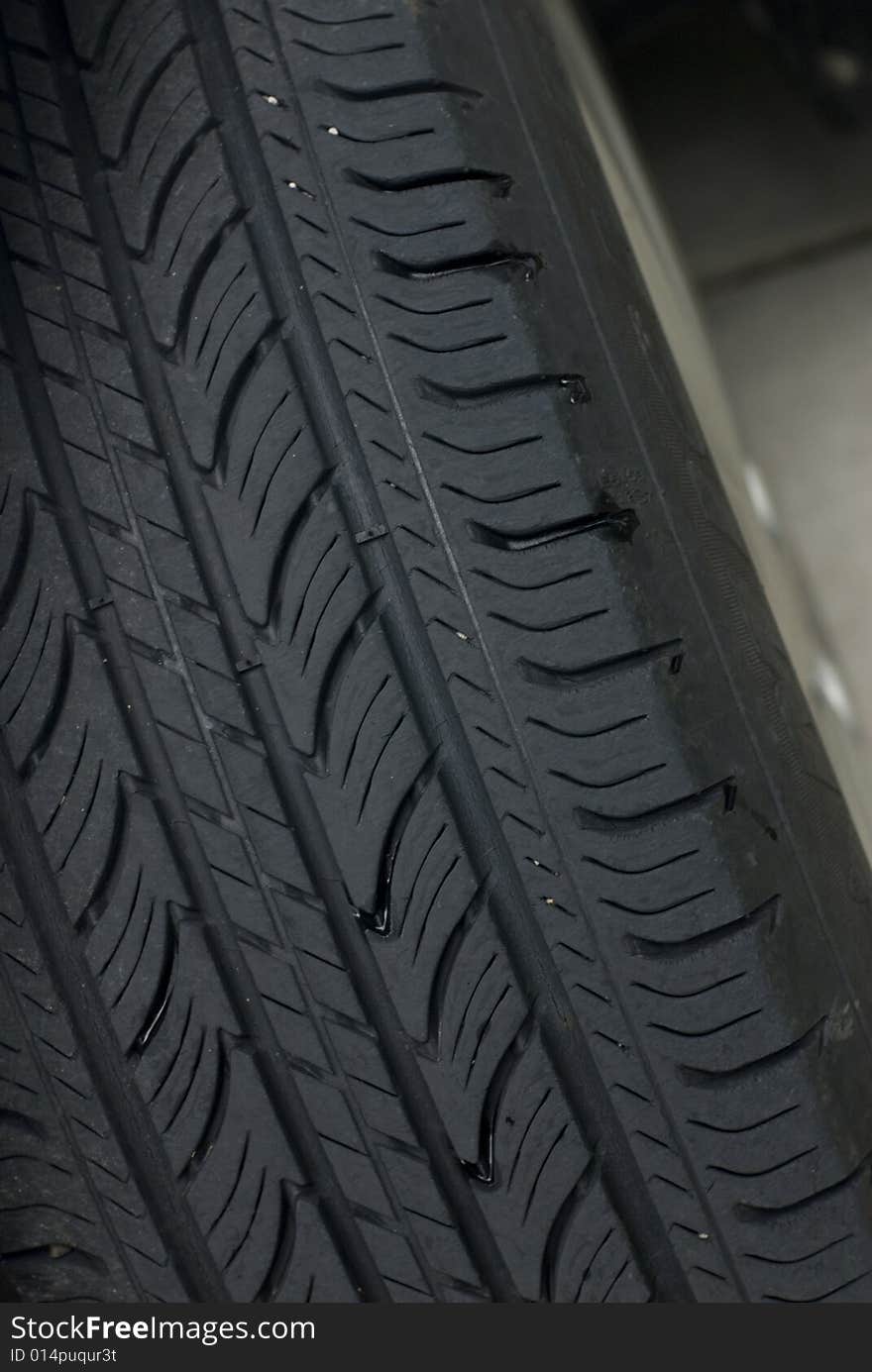 Closeup of a black car tire's tread. Closeup of a black car tire's tread