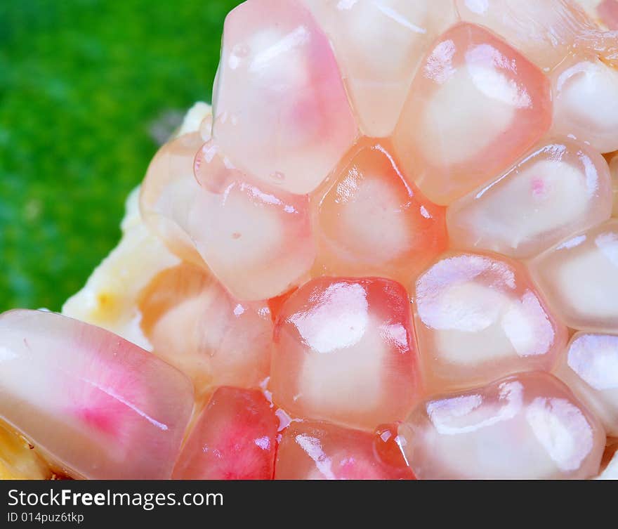 Close-up shot of pomegranate in green background