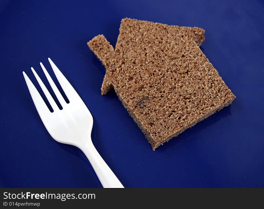 The silhouette of the house from bread lays on a plate. The silhouette of the house from bread lays on a plate.