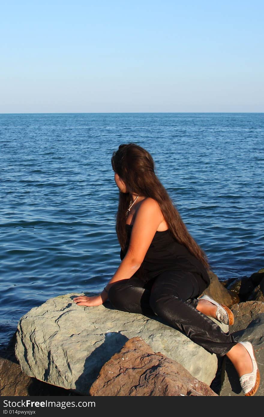 Beautiful attractive teenager model posing on sea beach. Beautiful attractive teenager model posing on sea beach