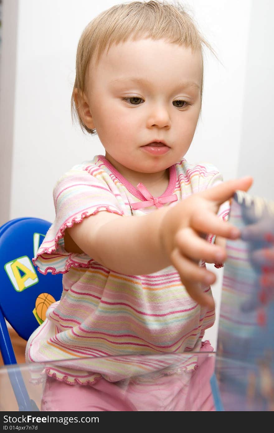 sweet toddler baby girl reading. sweet toddler baby girl reading