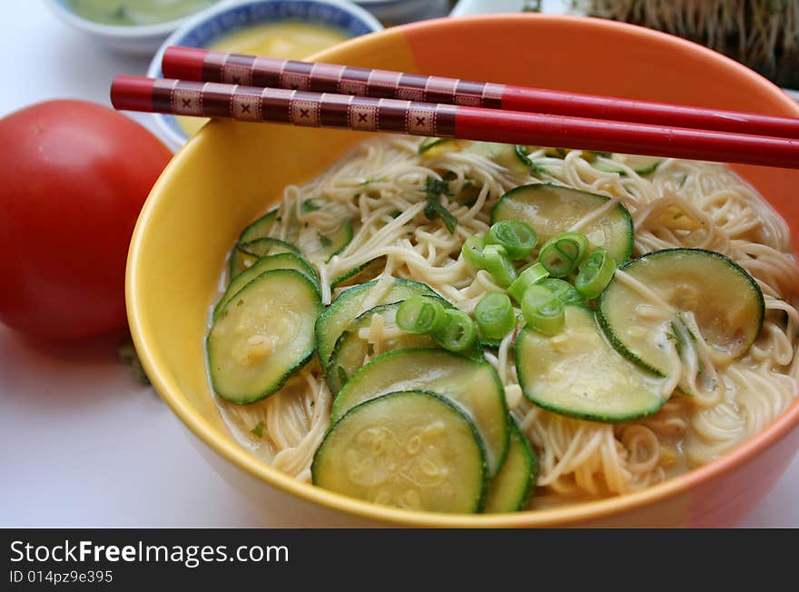 A fresh asian soup with zucchini and noodles. A fresh asian soup with zucchini and noodles