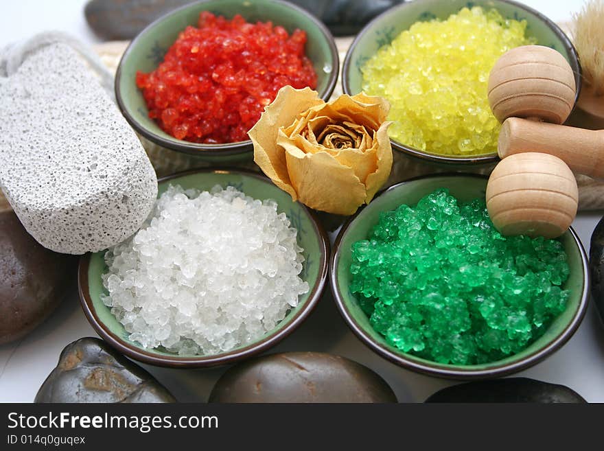 Some colourful salt for a bath and a rose. Some colourful salt for a bath and a rose