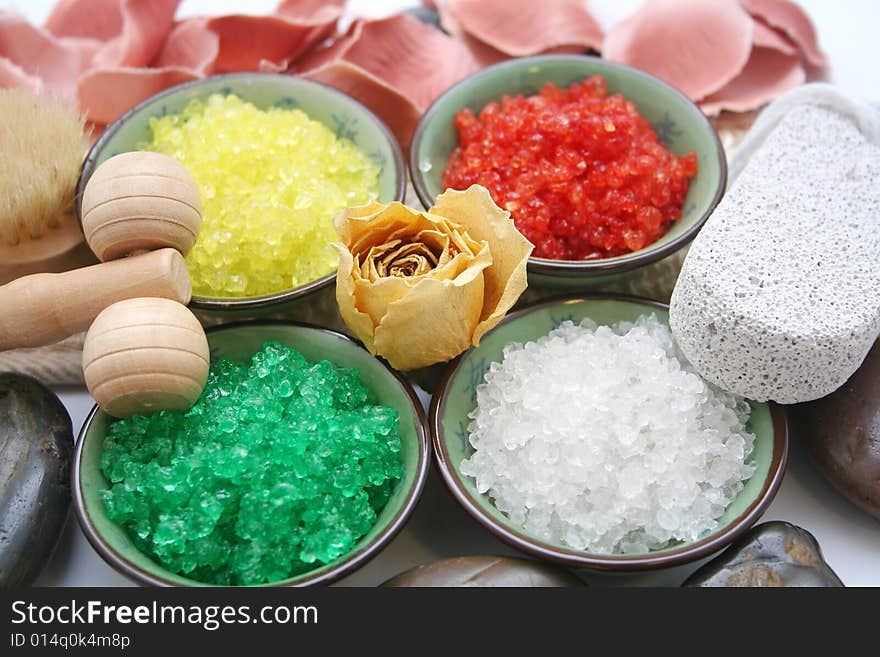 Some colourful salt for a bath and a rose. Some colourful salt for a bath and a rose