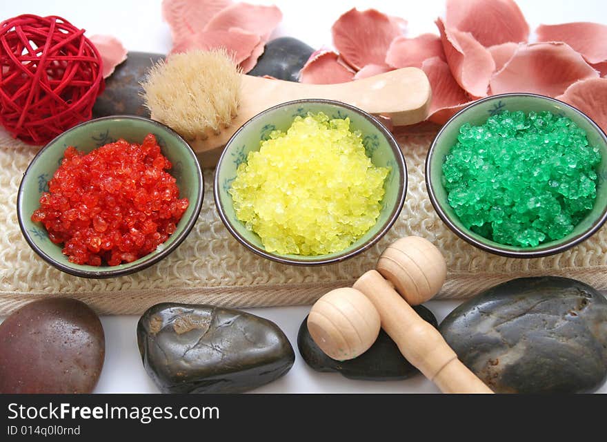 Some colourful salt for a bath and a rose. Some colourful salt for a bath and a rose