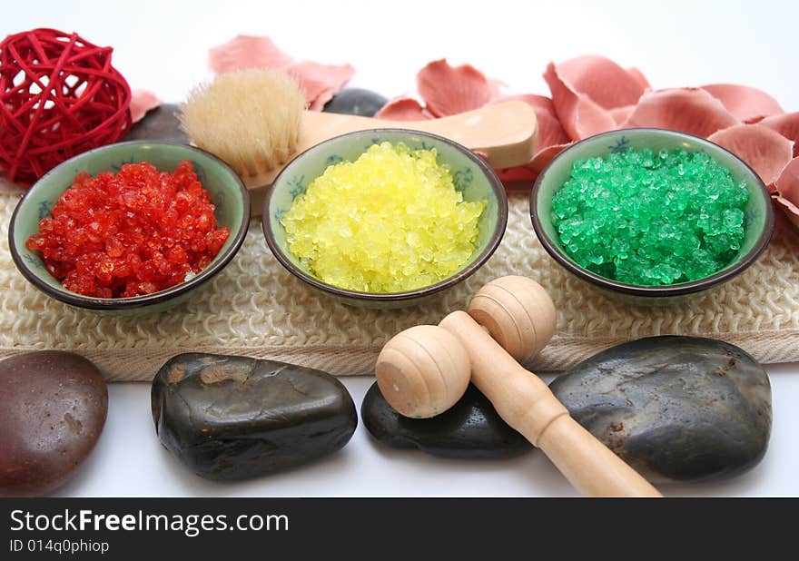 Some colourful salt for a bath and a rose. Some colourful salt for a bath and a rose