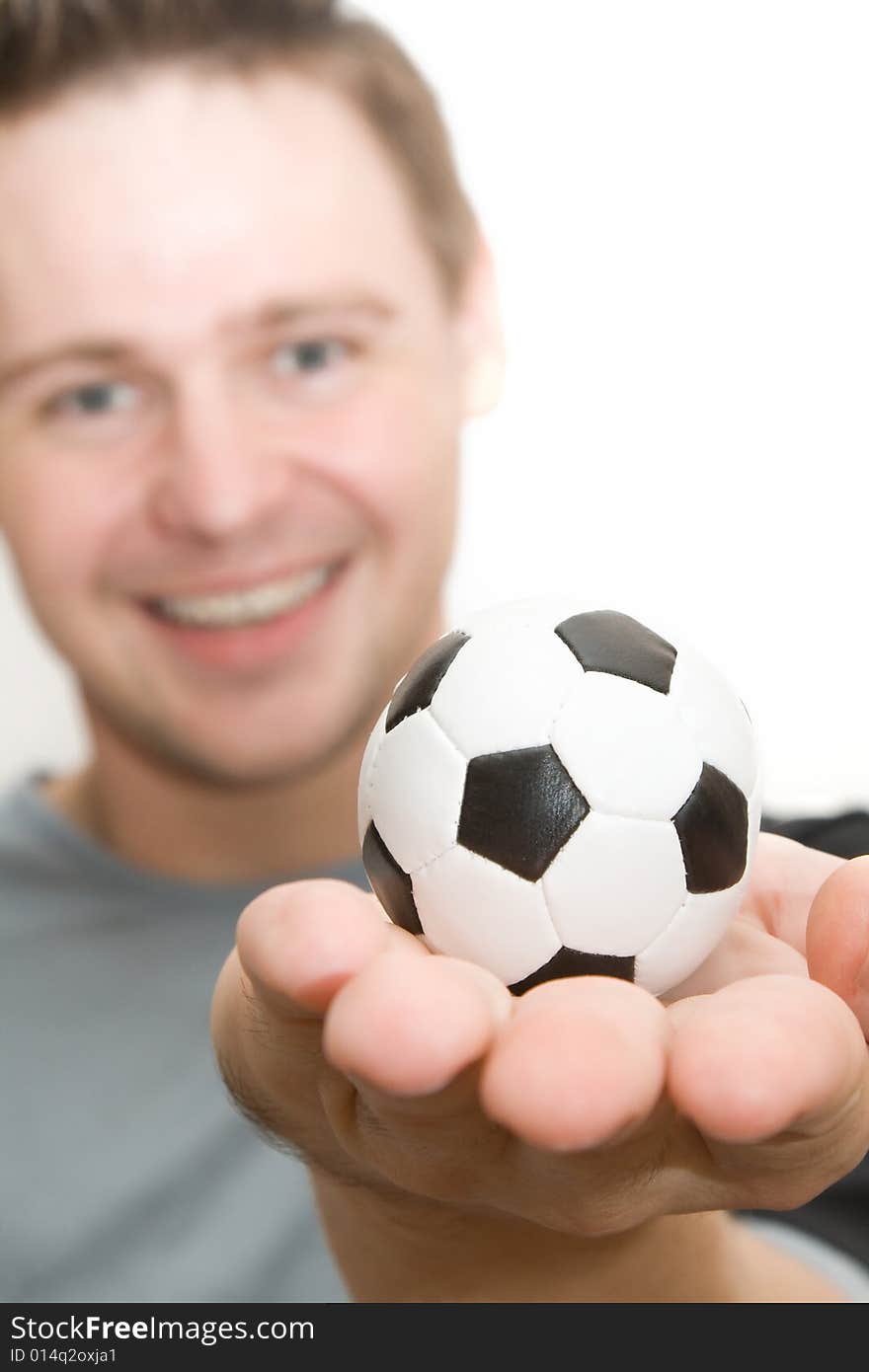 Soccer player holding a small ball