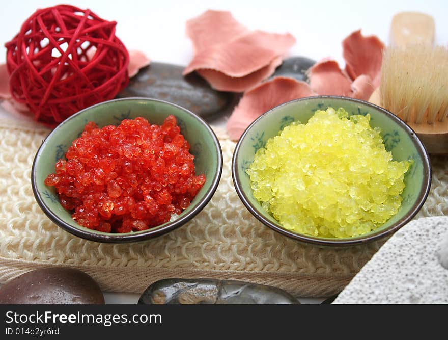 Some colourful salt for a bath and a rose. Some colourful salt for a bath and a rose