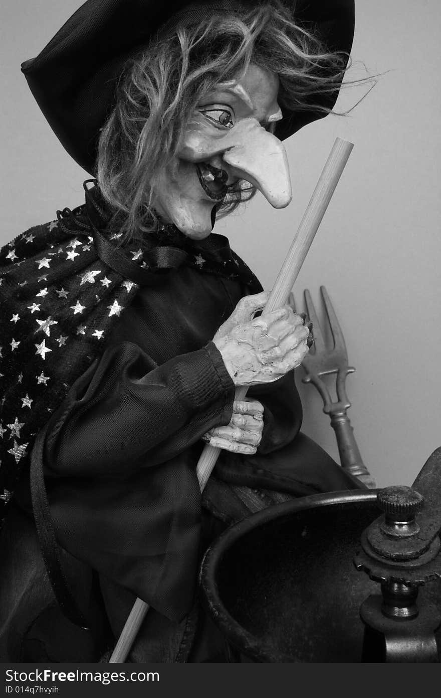 Ugly witch in gray with kitchen utensils. Ugly witch in gray with kitchen utensils