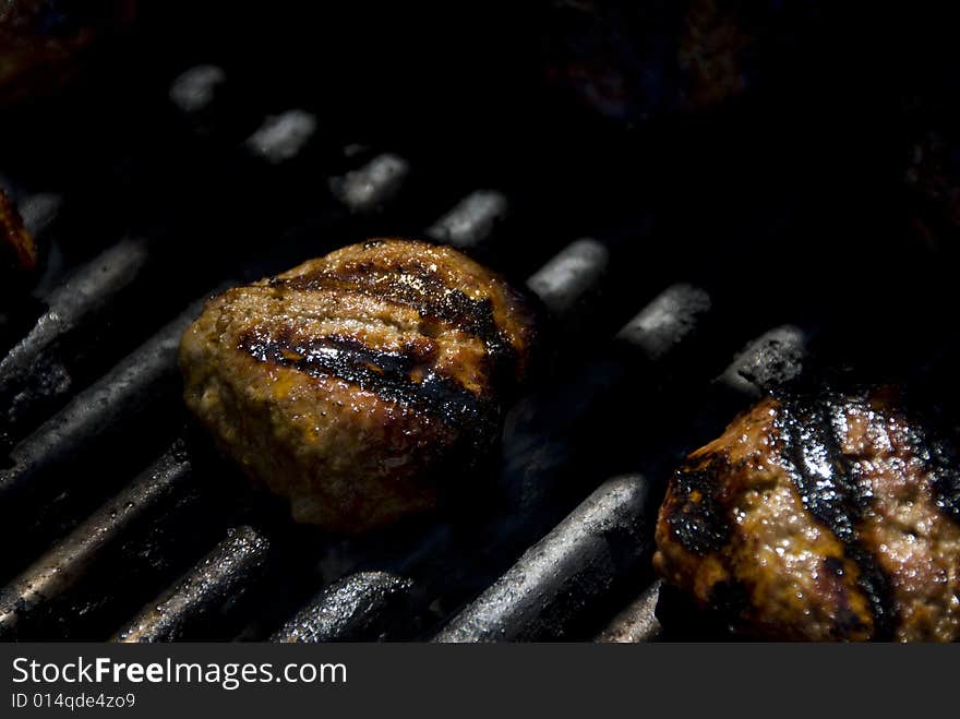 Closeup of hamburger patties being grilled. Closeup of hamburger patties being grilled