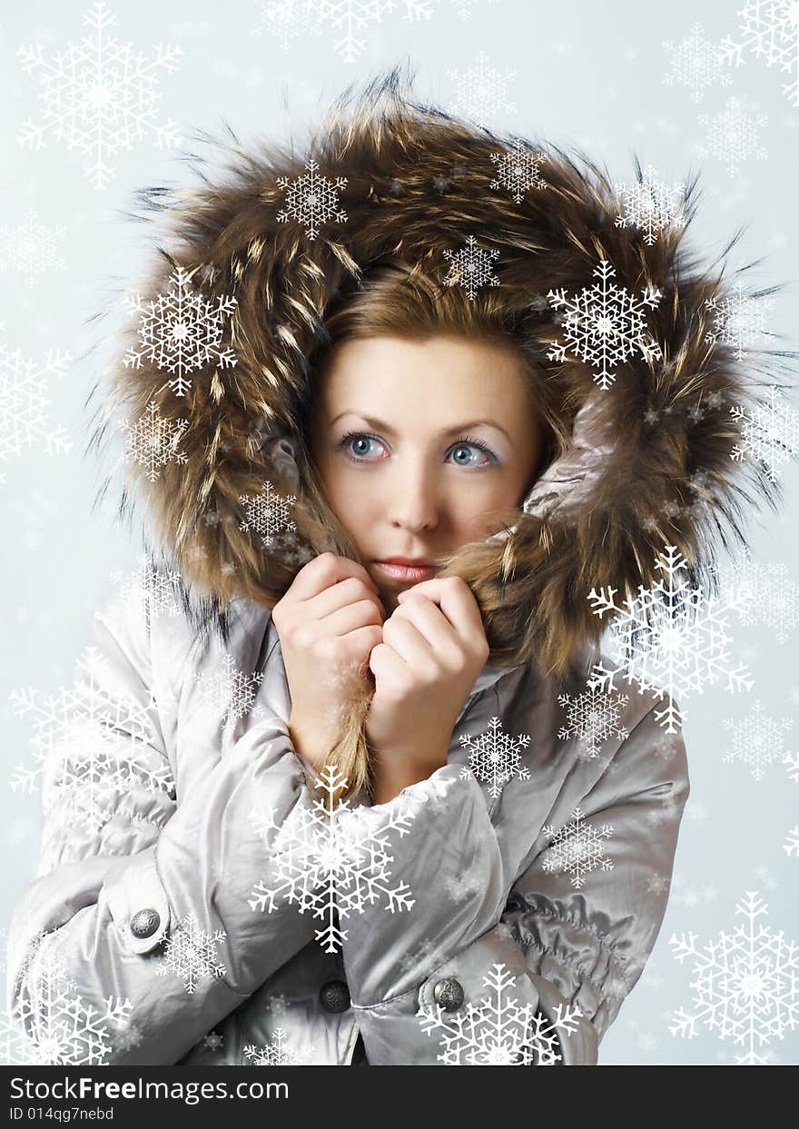 Young women under snow wearing a winter jacket. Young women under snow wearing a winter jacket